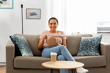 Image showing african woman eating food with chopsticks at home