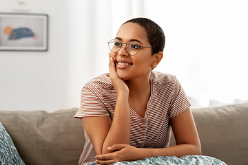 Image showing african american woman in glasses sitting on sofa