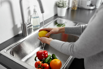 Image showing woman washing fruits and vegetables in kitchen