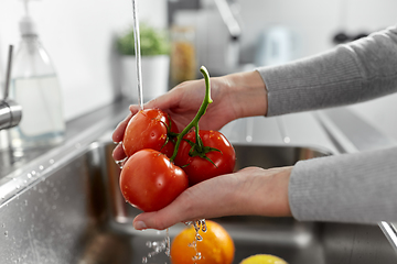 Image showing woman washing fruits and vegetables in kitchen