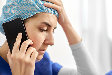 Image showing sad doctor or nurse calling on smartphone