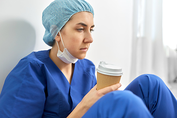 Image showing sad doctor or nurse with cup of takeaway coffee