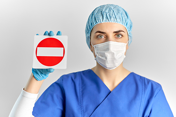 Image showing doctor or nurse in face mask showing stop sign