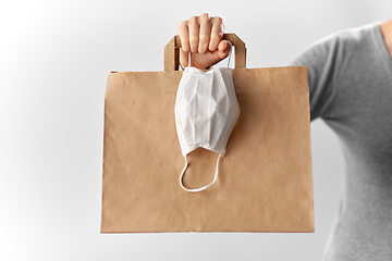 Image showing woman with shopping bag and face protective mask