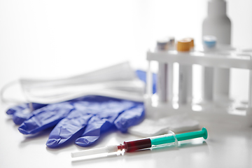 Image showing close up of blood in syringe, gloves and mask