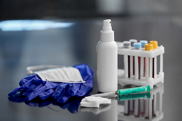 Image showing syringe, beakers with blood test, gloves and mask