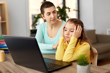 Image showing mother and daughter with laptop doing homework