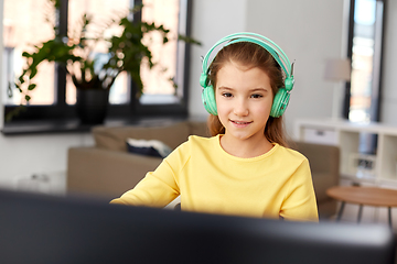 Image showing girl in headphones with laptop computer at home