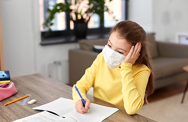 Image showing bored sick girl in medical mask learning at home