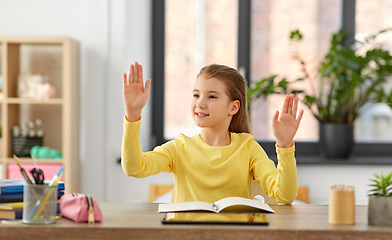 Image showing student girl touching something imaginary at home