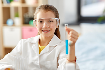 Image showing girl with test tube studying chemistry at home