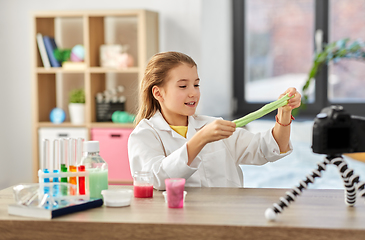 Image showing girl with slime and camera video blogging at home