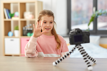 Image showing happy girl with camera video blogging at home