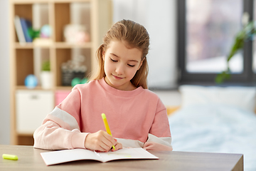 Image showing girl with notebook and marker drawing at home