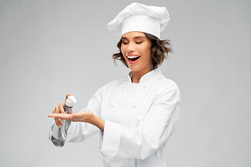 Image showing female chef with hand sanitizer or liquid soap