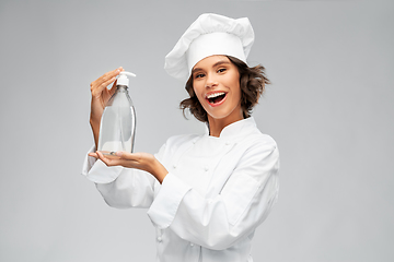 Image showing female chef with hand sanitizer or liquid soap
