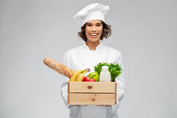 Image showing happy smiling female chef with food in wooden box