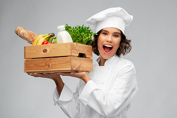 Image showing happy smiling female chef with food in wooden box