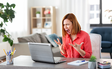 Image showing angry woman with laptop working at home office