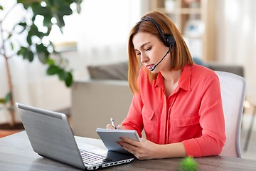 Image showing woman with headset and laptop working at home