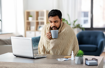 Image showing ill indian man in blanket drinking hot tea at home