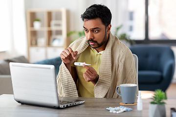 Image showing sick man thermometer having video call on laptop