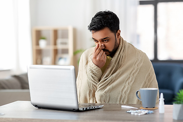 Image showing sick indian man having video call on laptop