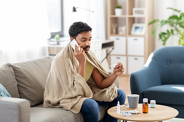 Image showing sick man with thermometer calling on smartphone