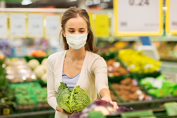 Image showing woman in mask buying savoy at grocery store