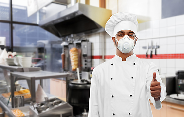 Image showing chef in respirator showing thumbs up at kitchen