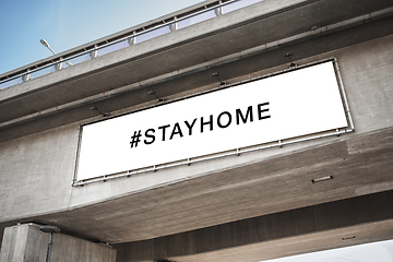 Image showing billboard with stay home words on concrete bridge