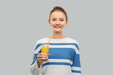 Image showing smiling teenage girl holding glass of orange juice