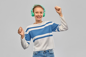 Image showing happy smiling teenage girl in headphones dancing