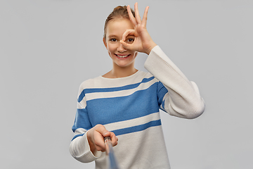 Image showing smiling teenage girl in pullover taking selfie