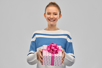 Image showing smiling teenage girl in pullover with gift box