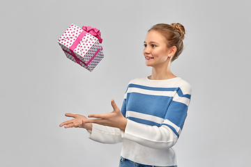 Image showing smiling teenage girl in pullover with gift box