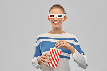 Image showing teenage girl in 3d movie glasses eating popcorn