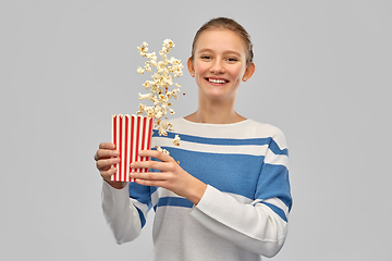 Image showing smiling teenage girl with popcorn