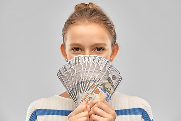 Image showing smiling teenage girl with dollar money banknotes