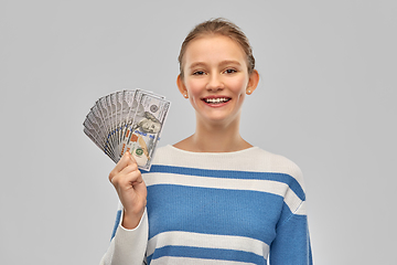 Image showing smiling teenage girl with dollar money banknotes