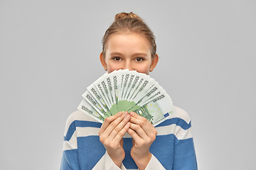 Image showing smiling teenage girl with euro money banknotes