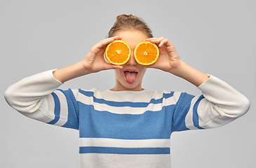 Image showing funny teenage girl with oranges instead of eyes