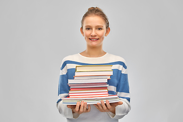 Image showing happy smiling teenage student girl with books