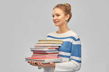 Image showing happy smiling teenage student girl with books