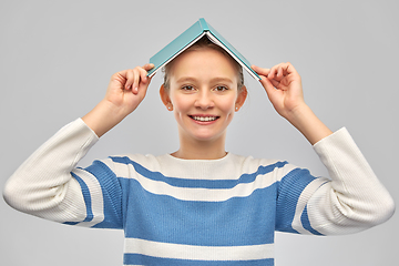 Image showing happy smiling teenage student girl with book