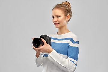 Image showing smiling teenage girl r with digital camera