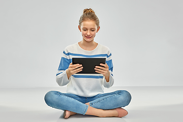 Image showing happy smiling teenage girl using tablet computer