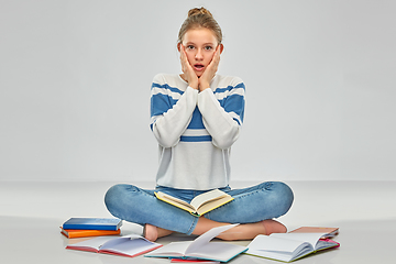 Image showing stressed teenage student girl with books