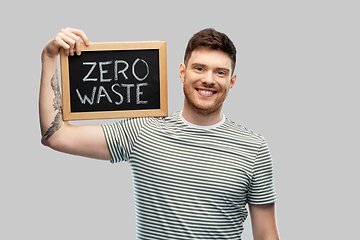 Image showing smiling man holding chalkboard with zero waste