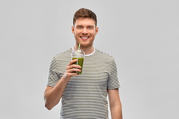 Image showing man drinking green smoothie from disposable cup